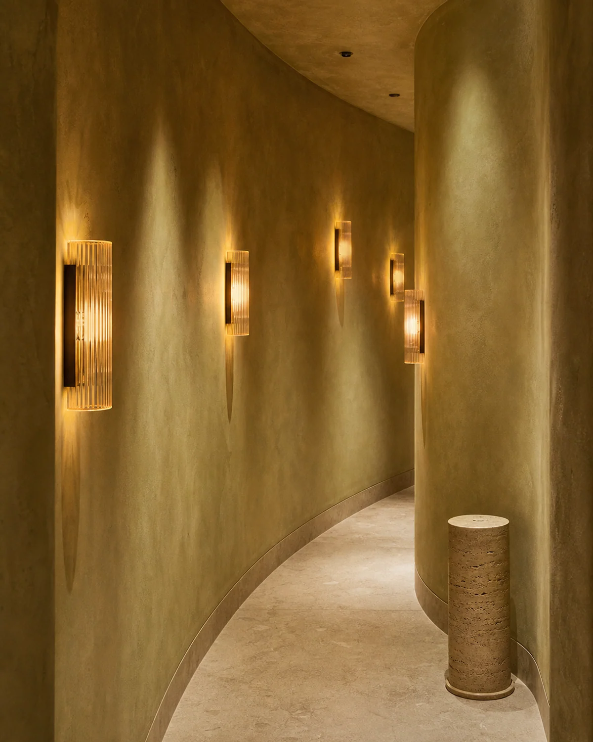 Amber Glass Sconces in a Curved Hall — Hallway