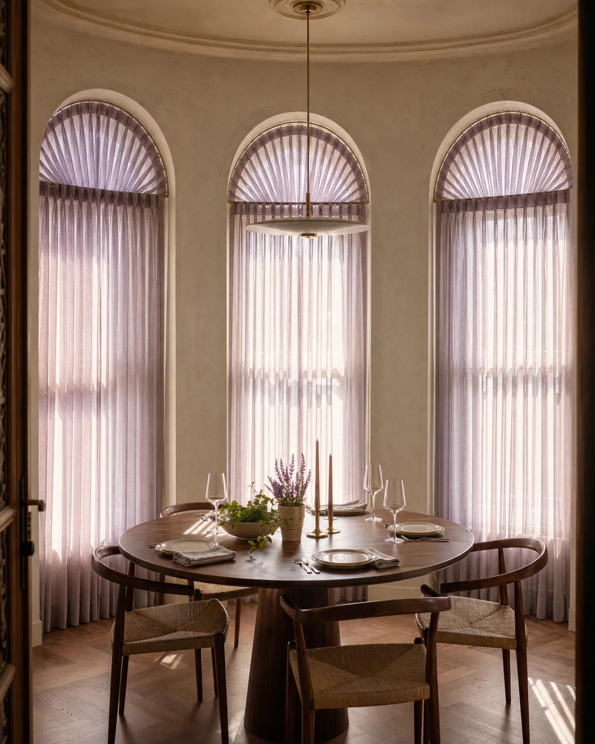 Fan-Pleated Sheers Within Arched Windows — Dining room